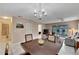 Dining area features a chandelier, a wood table, and views into the living room and beyond at 120 Knollpoint Dr, Sun City Center, FL 33573