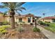 Charming single-story home with a well-maintained front yard and lush tropical landscaping at 120 Knollpoint Dr, Sun City Center, FL 33573