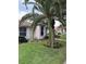 Inviting home exterior with vibrant landscaping featuring palm trees and lush greenery enhances curb appeal at 120 Knollpoint Dr, Sun City Center, FL 33573