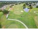 Picturesque golf course featuring lush greenery, sand traps, a pond, and walking paths at 120 Knollpoint Dr, Sun City Center, FL 33573