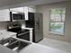 Functional kitchen with stainless steel appliances, white cabinets, and ample counter space at 120 Knollpoint Dr, Sun City Center, FL 33573