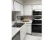 Well-equipped kitchen featuring white cabinets, stainless steel appliances, and ample counter space at 120 Knollpoint Dr, Sun City Center, FL 33573