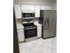 Modern kitchen with stainless steel appliances, white cabinetry, and convenient layout at 120 Knollpoint Dr, Sun City Center, FL 33573
