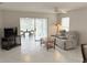 Comfortable living space featuring cozy seating, ceiling fan, and access to the outdoor lanai at 120 Knollpoint Dr, Sun City Center, FL 33573