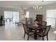 Bright living area with sliding doors to lanai, comfortable seating, and dining space at 120 Knollpoint Dr, Sun City Center, FL 33573