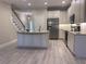 Modern kitchen with stainless steel appliances, granite countertops, and a center island at 12311 Terracina Chase Ct, Tampa, FL 33625