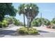 Landscaped entrance to a community with palm trees and street lamps at 537 Dolphin Se Ave, St Petersburg, FL 33705