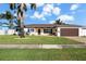 Single story home with a paver driveway, landscaped lawn, and two-car garage at 537 Dolphin Se Ave, St Petersburg, FL 33705