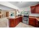 Kitchen boasts granite counters, wood cabinets, and pool view at 537 Dolphin Se Ave, St Petersburg, FL 33705
