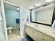 Bathroom with vanity, toilet and access to a second bathroom at 3035 Countryside Blvd # 14B, Clearwater, FL 33761