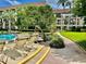 Steps leading to the pool with lounge chairs and landscaping at 3035 Countryside Blvd # 14B, Clearwater, FL 33761