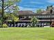 Golf course clubhouse with numerous golf carts parked outside at 3035 Countryside Blvd # 14B, Clearwater, FL 33761