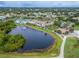 Community clubhouse with pool and surrounding landscape at 120 Knollpoint Dr, Sun City Center, FL 33573