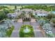Community clubhouse entrance with fountain and palm trees at 120 Knollpoint Dr, Sun City Center, FL 33573