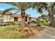 Well-maintained landscaping with palm trees at 120 Knollpoint Dr, Sun City Center, FL 33573