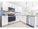 Modern kitchen with white shaker cabinets and stainless steel appliances at 31355 Amberview Bnd, Wesley Chapel, FL 33545