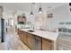 Island kitchen with stainless steel appliances and light wood cabinets at 833 Bay Point Dr, Madeira Beach, FL 33708