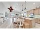 Open concept kitchen with an island, dining area, and water views at 833 Bay Point Dr, Madeira Beach, FL 33708