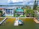 Waterfront property with private dock, showcasing the home and surroundings at 833 Bay Point Dr, Madeira Beach, FL 33708