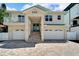 Two-story house with a two car garage and a nicely landscaped front yard at 833 Bay Point Dr, Madeira Beach, FL 33708