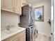 Laundry room with stacked washer and dryer, and utility sink at 833 Bay Point Dr, Madeira Beach, FL 33708
