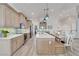 Modern kitchen with an eat-in island and light wood cabinets at 833 Bay Point Dr, Madeira Beach, FL 33708