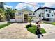 Two-story house with a two car garage and a nicely landscaped front yard at 833 Bay Point Dr, Madeira Beach, FL 33708