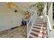 White staircase leading from the patio to the lower level at 833 Bay Point Dr, Madeira Beach, FL 33708