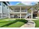 Two-story house with backyard, patio, and putting green at 833 Bay Point Dr, Madeira Beach, FL 33708