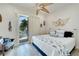 Bedroom with king-size bed, balcony access, and coastal decor at 833 Bay Point Dr, Madeira Beach, FL 33708