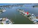 Aerial view showcasing waterfront property with boat access and canal views at 833 Bay Point Dr, Madeira Beach, FL 33708