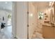Small bathroom with shower, toilet, and granite vanity at 833 Bay Point Dr, Madeira Beach, FL 33708