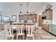 Bright kitchen features an island with seating and white cabinets at 833 Bay Point Dr, Madeira Beach, FL 33708