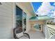 Relaxing balcony with wicker chair and partial water views at 833 Bay Point Dr, Madeira Beach, FL 33708