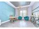 Stylish home office featuring a teal accent wall and built-in shelving at 2924 Valencia Ridge St, Valrico, FL 33596