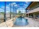 Resort-style pool with waterfall feature and screened enclosure at 2924 Valencia Ridge St, Valrico, FL 33596