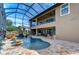 Resort-style pool with waterfall, screened enclosure, and spacious patio at 2924 Valencia Ridge St, Valrico, FL 33596