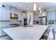 Modern kitchen with gray cabinets, quartz countertops, and mosaic backsplash at 2924 Valencia Ridge St, Valrico, FL 33596