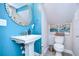 Small powder room with pedestal sink and teal walls at 2924 Valencia Ridge St, Valrico, FL 33596