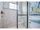 Clean bathroom with a walk-in shower and neutral tile at 2924 Valencia Ridge St, Valrico, FL 33596
