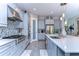 Modern kitchen with gray cabinets, quartz countertops, and mosaic backsplash at 2924 Valencia Ridge St, Valrico, FL 33596
