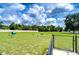 Community dog park with grassy area, benches, and pet waste stations at 2924 Valencia Ridge St, Valrico, FL 33596