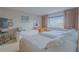 Bright bedroom featuring three twin beds with white bedding and a beautiful water view at 31 Island Way # 907, Clearwater Beach, FL 33767