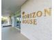 Entrance to building with signage, 'Horizon House,' features modern architecture and clean, welcoming design at 31 Island Way # 907, Clearwater Beach, FL 33767