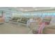 Well-furnished common area with seating, tables, and a ping pong table with water view at 31 Island Way # 907, Clearwater Beach, FL 33767