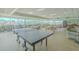 Spacious community area featuring tables, chairs, a ping pong table, books and bicycles at 31 Island Way # 907, Clearwater Beach, FL 33767