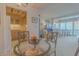 Cozy dining area with a glass-top table, views of the city, and access to the kitchen and living room at 31 Island Way # 907, Clearwater Beach, FL 33767