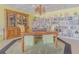 Dining area with a wooden table, chairs, decorative hutch, and bookcase at 31 Island Way # 907, Clearwater Beach, FL 33767