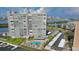 Exterior view of a condo building, featuring waterfront views, a pool, and covered parking at 31 Island Way # 907, Clearwater Beach, FL 33767