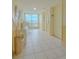 Bright hallway with elevator access and seating area offering a glimpse of the waterfront view at 31 Island Way # 907, Clearwater Beach, FL 33767